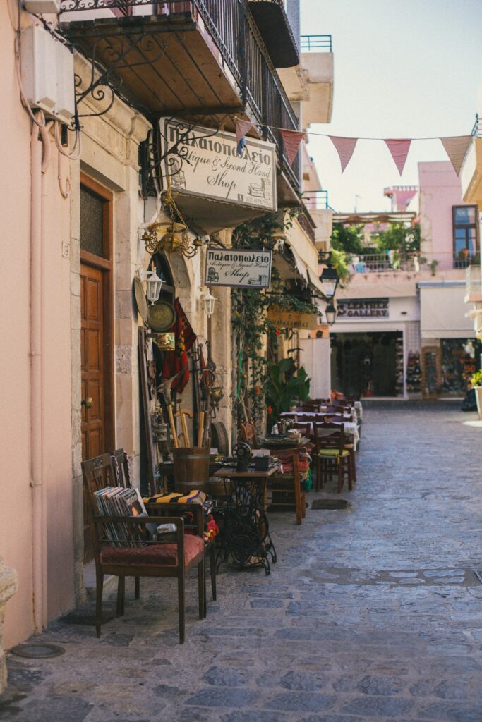 Charming antique shop on a cobblestone street in Greece with vintage furniture and decor