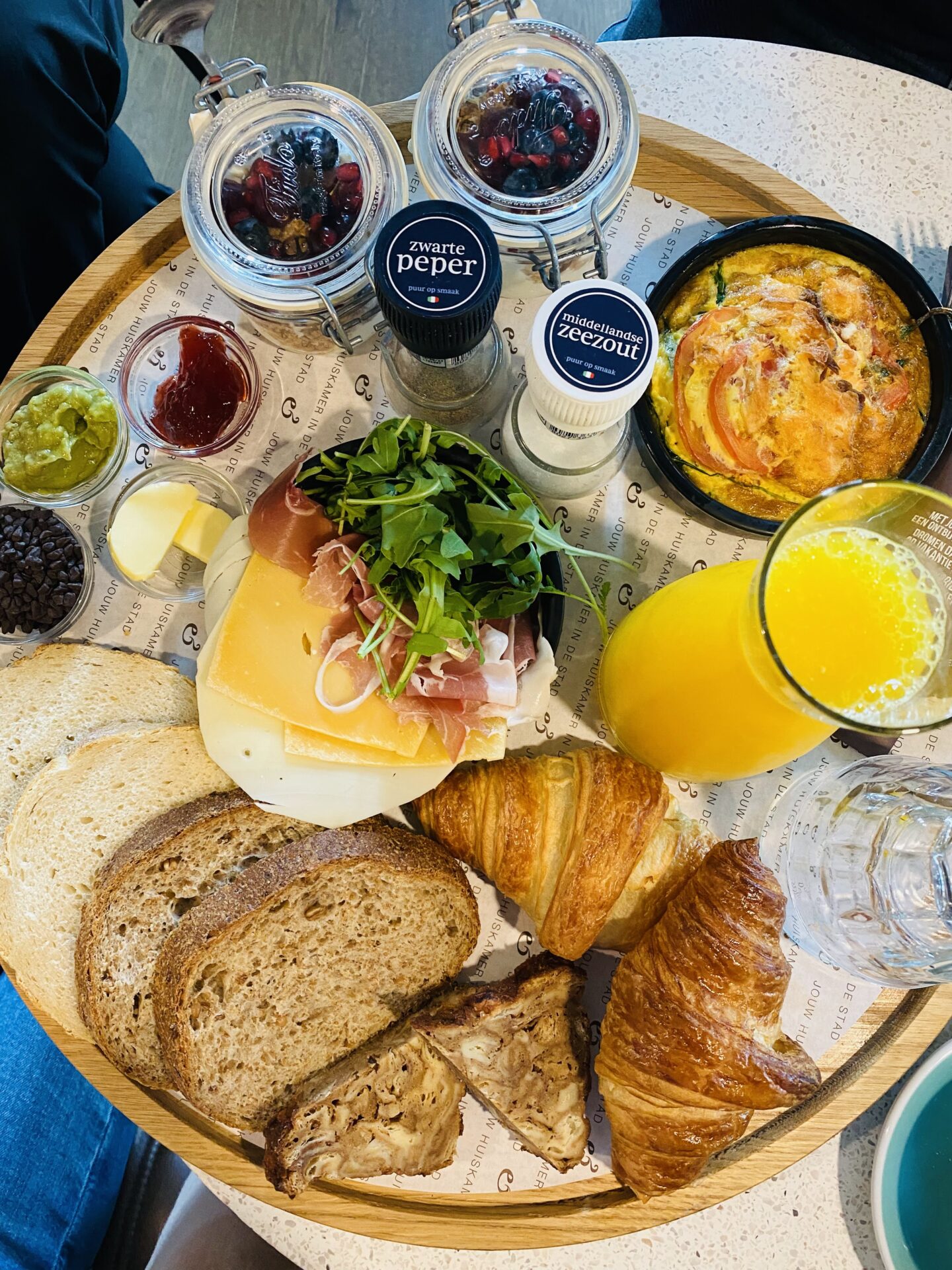 Dutch breakfast spread with croissants, cheese and fresh juice at an Amsterdam cafe