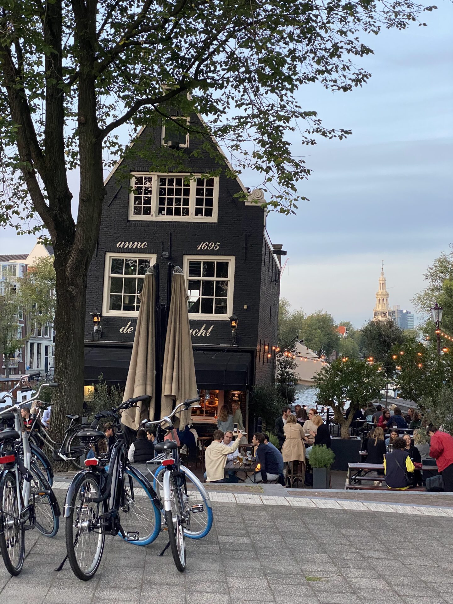 Anno 1695 restaurant in Amsterdam with bicycles parked outside in the evening