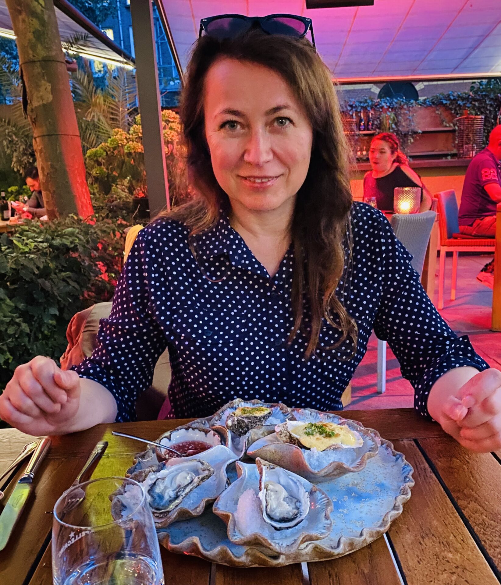 Dinner with oysters at an Amsterdam restaurant terrace in the evening