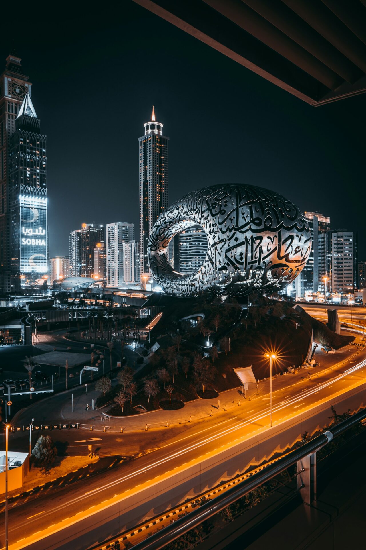 Museum of the Future Dubai at night with illuminated facade and city lights